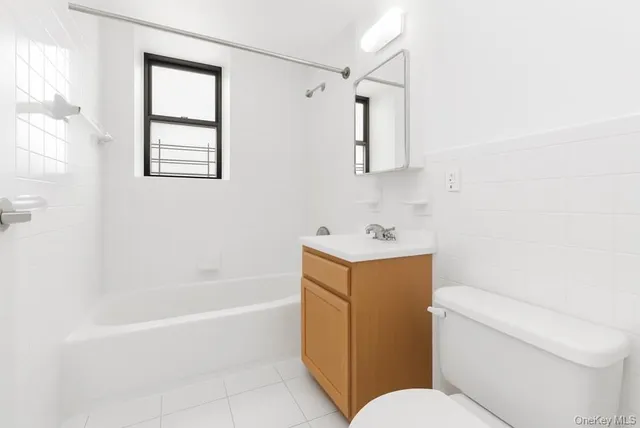 a bathroom with a sink mirror vanity and toilet