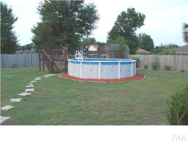 7185 Woodside Road Pensacola, FL 32526 - Photo 18 of 19 Above ground pool with a gated deck half-way around it.