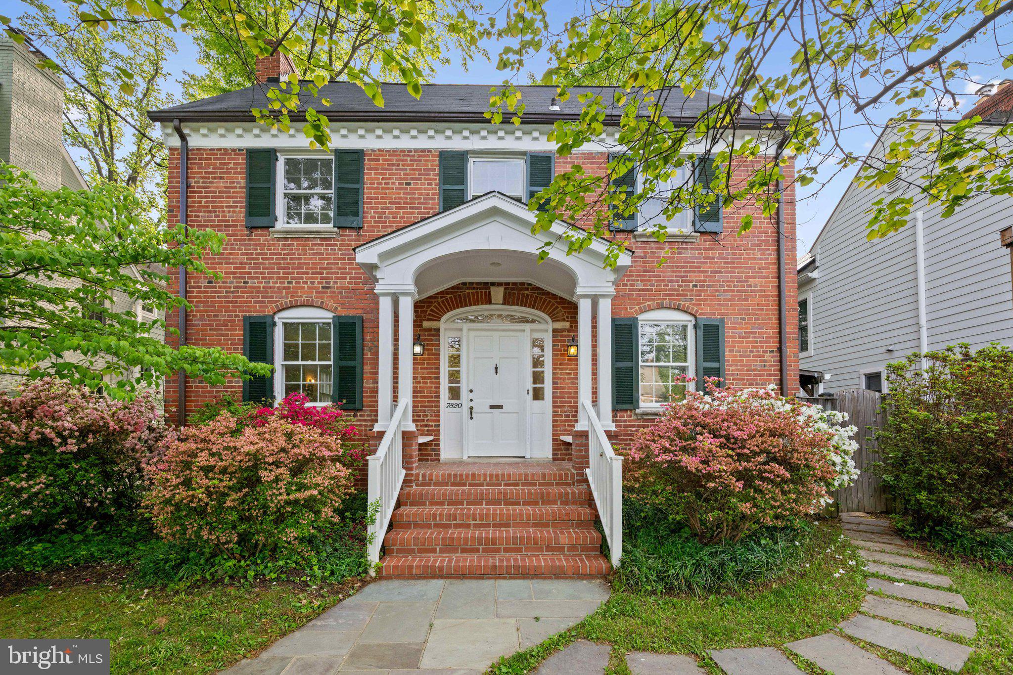 7820 Custer Road Bethesda, MD 20814 - Photo 1 of 29 a front view of a house with a garden