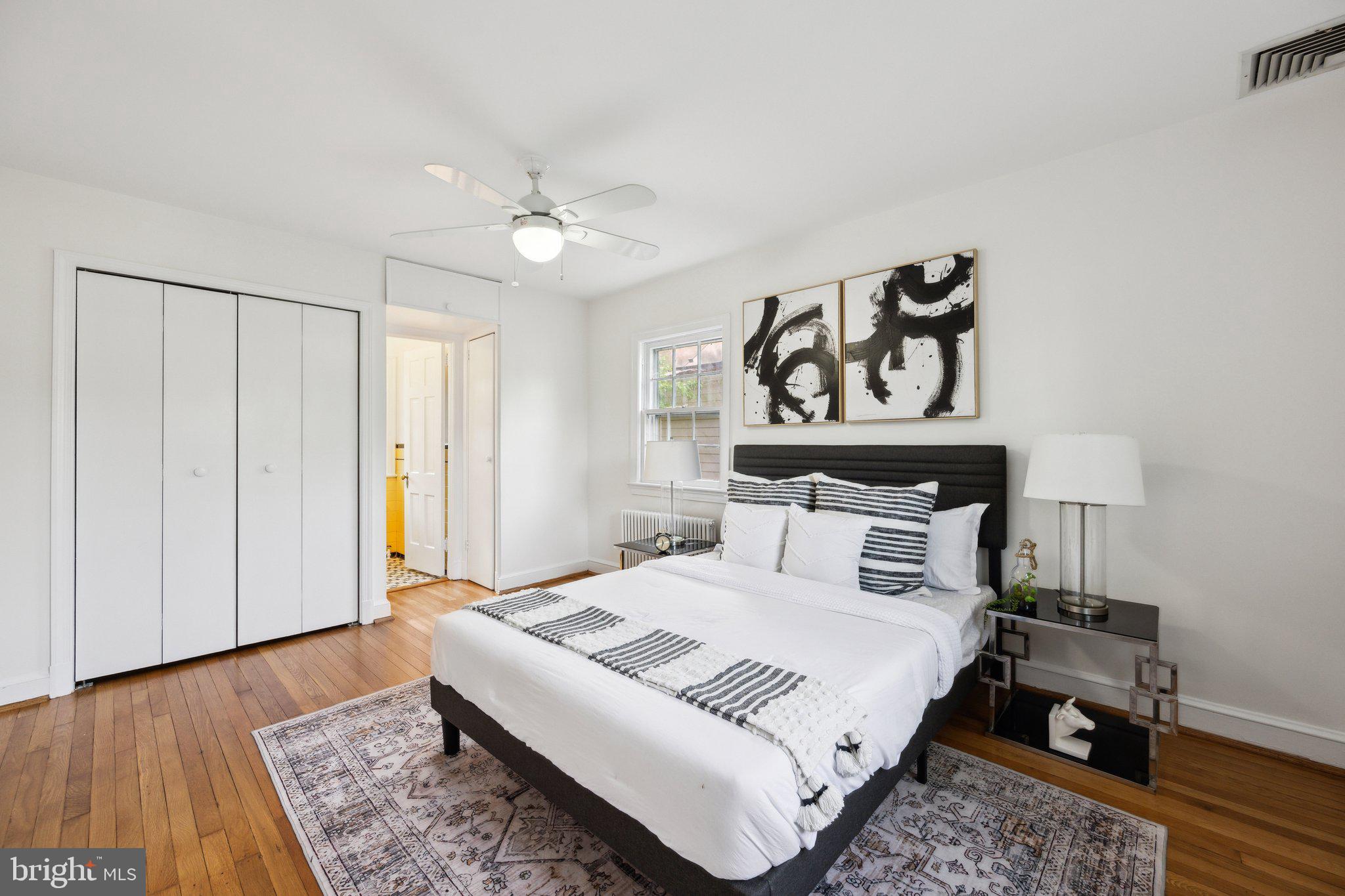 7820 Custer Road Bethesda, MD 20814 - Photo 11 of 29 a bedroom with a bed and wooden floor