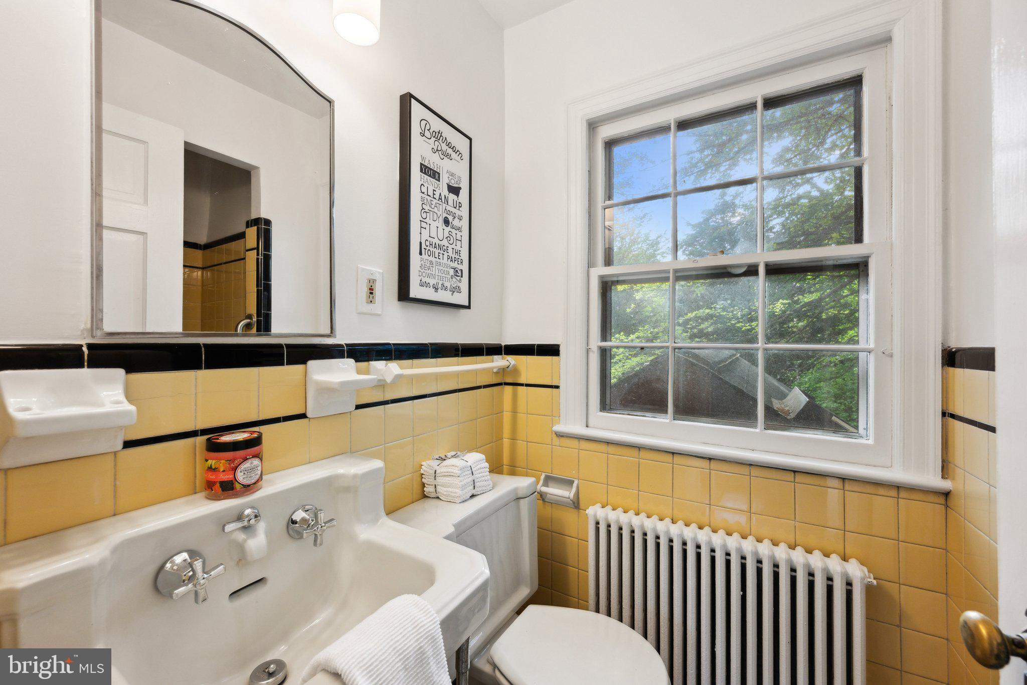 7820 Custer Road Bethesda, MD 20814 - Photo 13 of 29 a bathroom with a sink and a large mirror next to a window