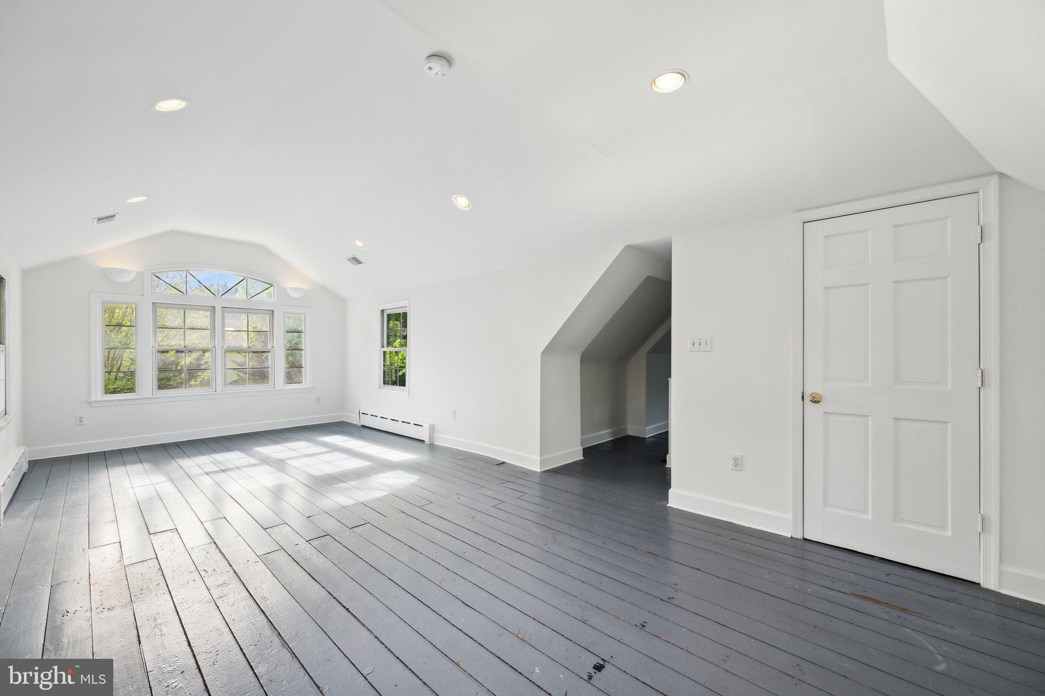 7820 Custer Road Bethesda, MD 20814 - Photo 21 of 29 an empty room with wooden floor and windows