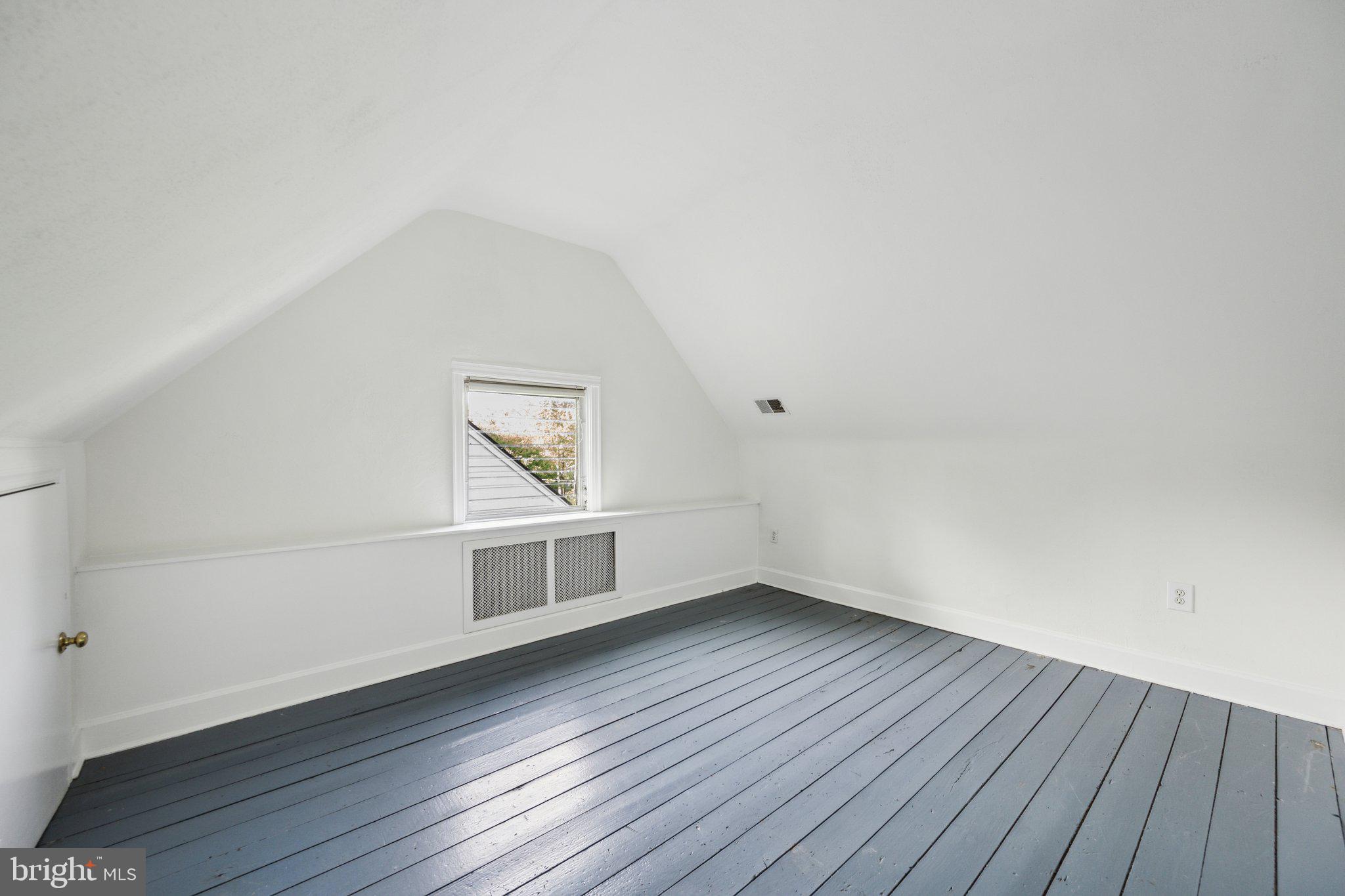 7820 Custer Road Bethesda, MD 20814 - Photo 22 of 29 a view of an empty room with wooden floor and a window