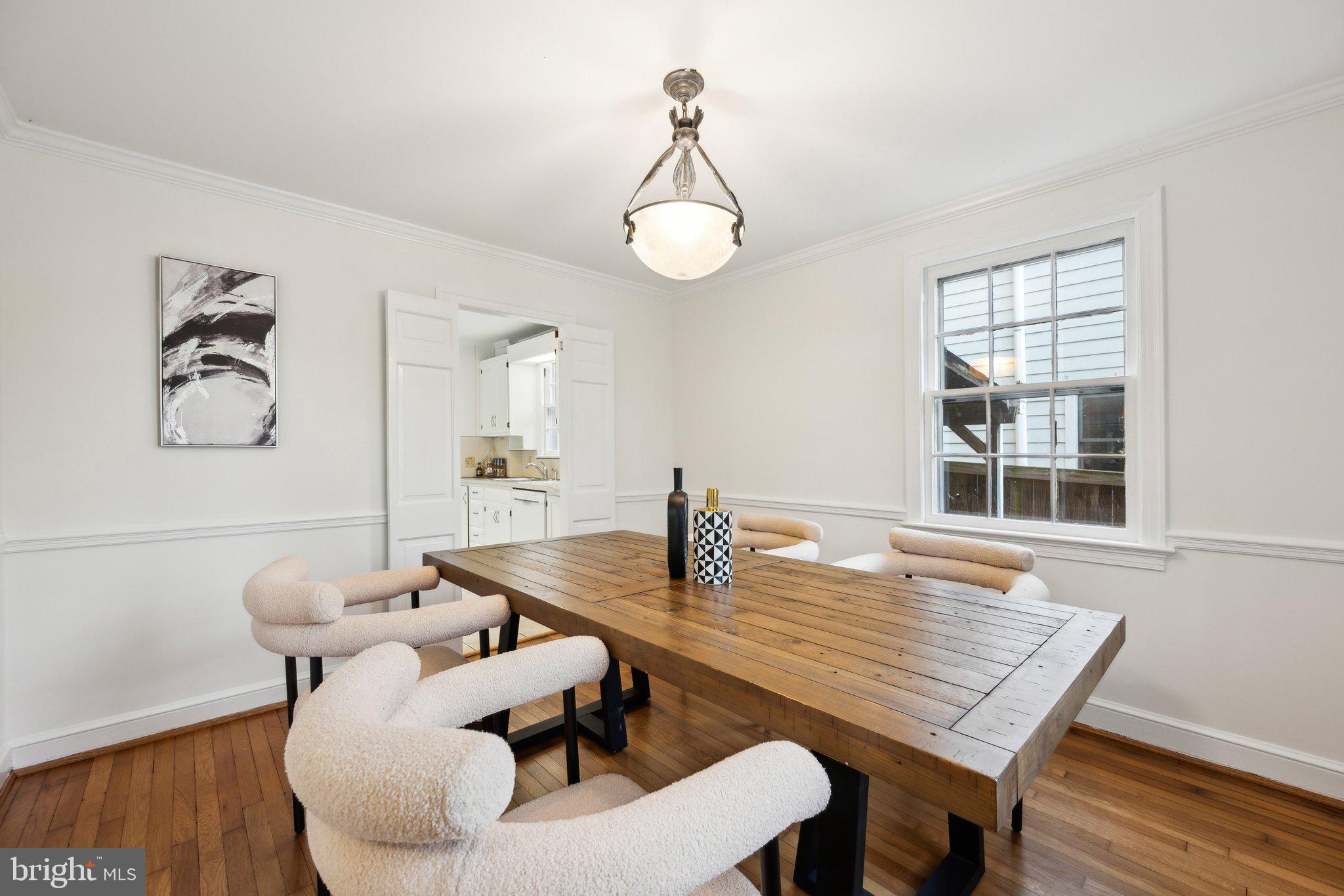 7820 Custer Road Bethesda, MD 20814 - Photo 3 of 29 a view of a dining room with furniture and wooden floor