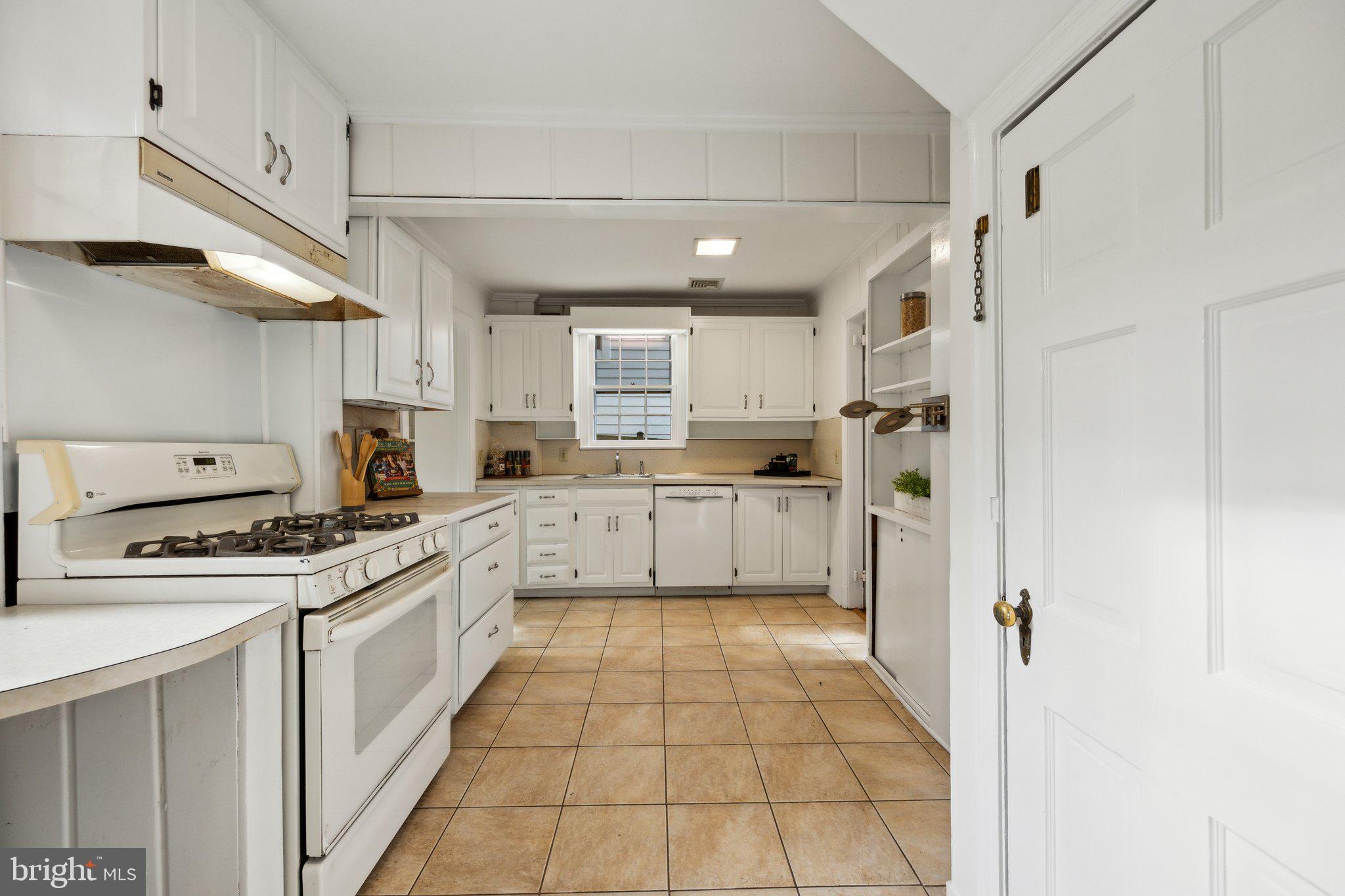 7820 Custer Road Bethesda, MD 20814 - Photo 5 of 29 a large kitchen with cabinets and stainless steel appliances