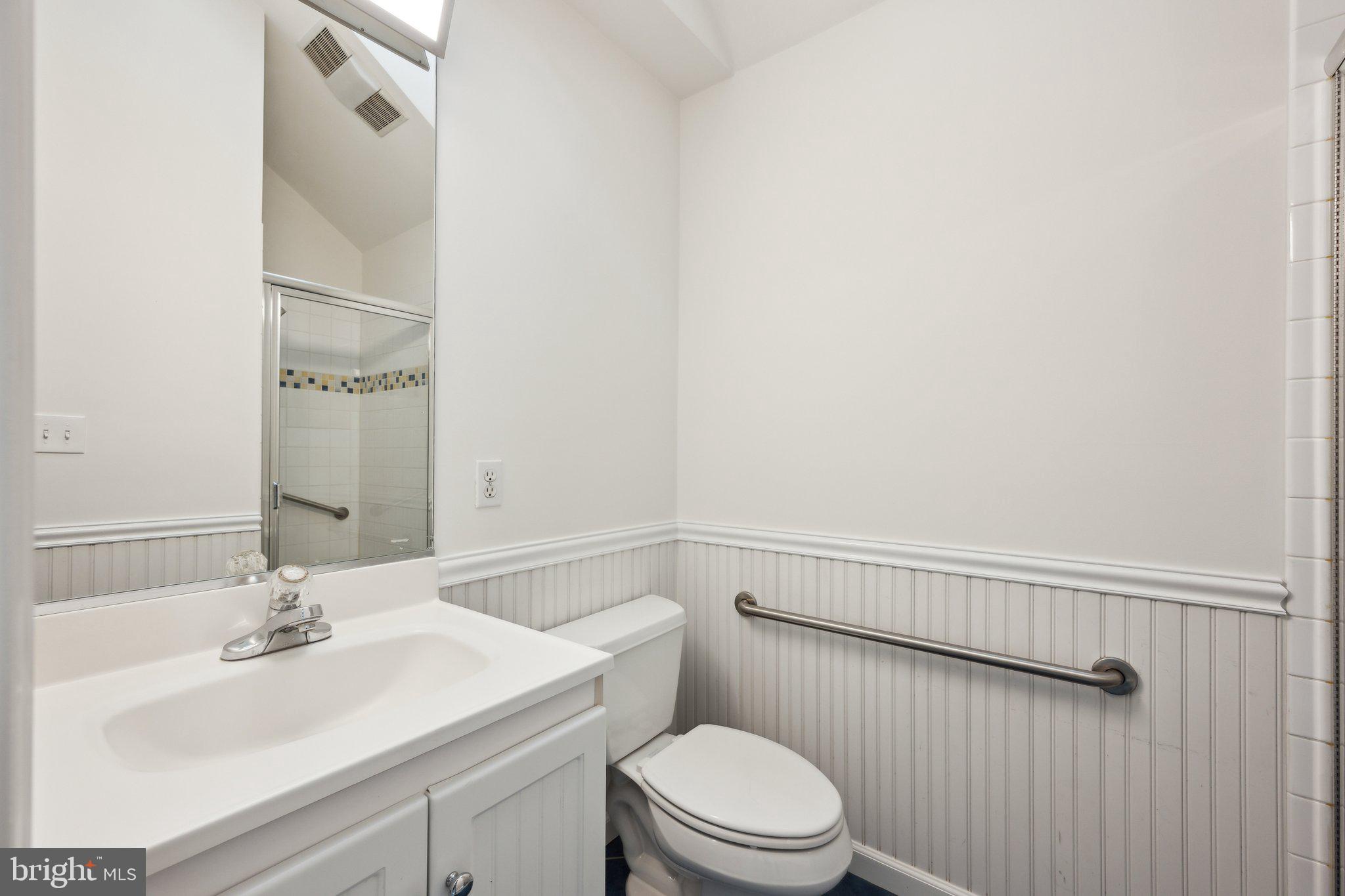 7820 Custer Road Bethesda, MD 20814 - Photo 10 of 29 a bathroom with a sink a toilet and shower