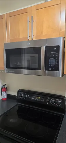 a stove top oven sitting inside of a kitchen