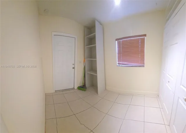 a view of an empty room with a bathroom