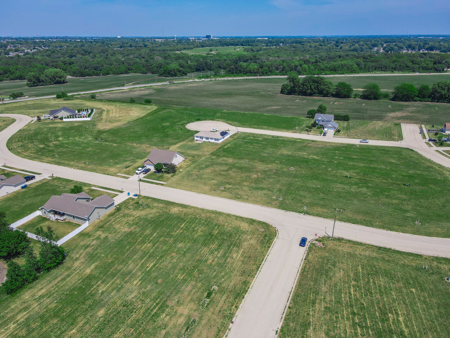 1408 Indian Trail Kankakee, IL 60901 - Photo 5 of 8 a view of a lake with a yard and large trees