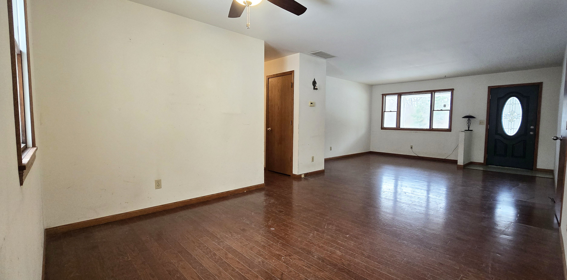 1115 South Clapper Court Mahomet, IL 61853 - Photo 3 of 16 an empty room with wooden floor and windows