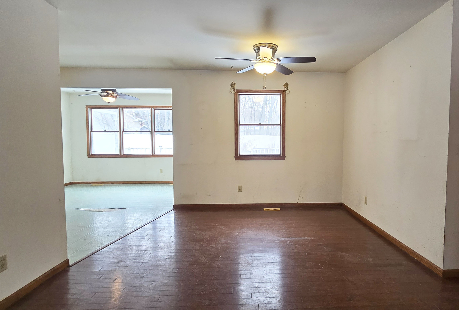 1115 South Clapper Court Mahomet, IL 61853 - Photo 4 of 16 an empty room with wooden floor chandelier and windows