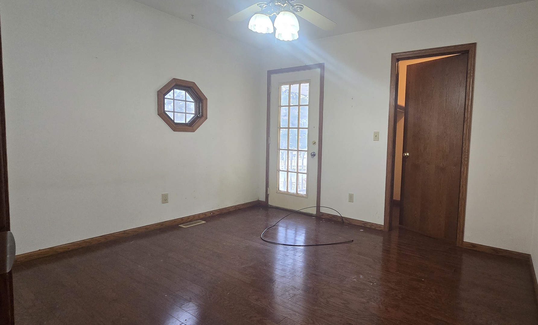 1115 South Clapper Court Mahomet, IL 61853 - Photo 9 of 16 an empty room with wooden floor and windows