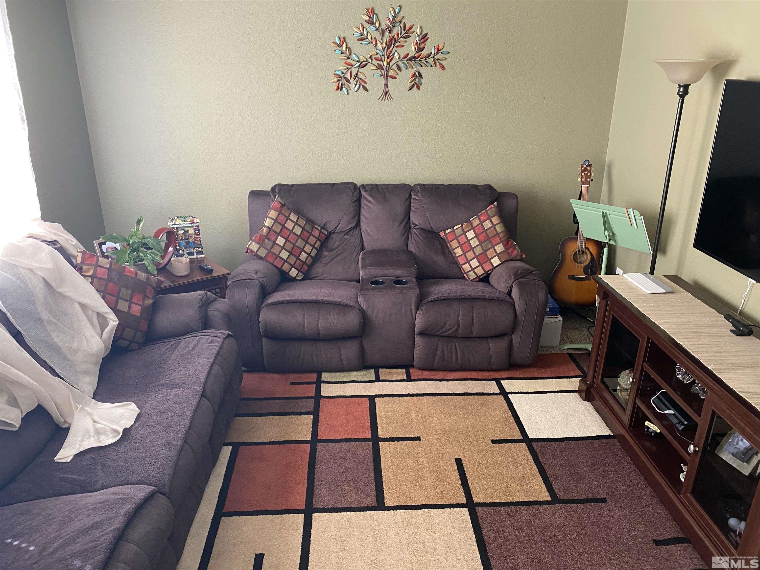 3941 Clear Acre Lane, Unit 235 Reno, NV 89512 - Photo 2 of 3 a living room with furniture and a flat screen tv