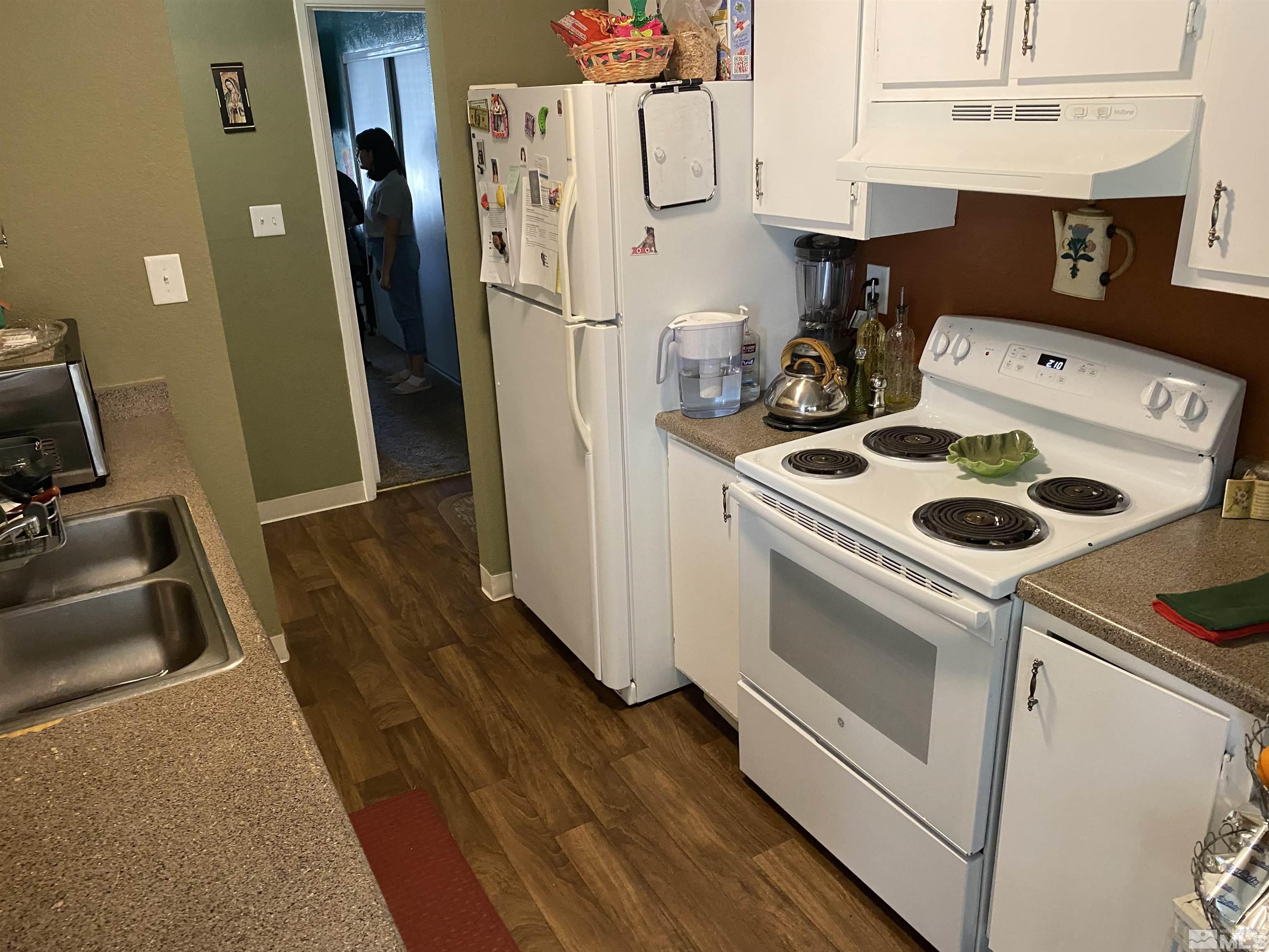 3941 Clear Acre Lane, Unit 235 Reno, NV 89512 - Photo 3 of 3 a kitchen with a stove a refrigerator and a sink