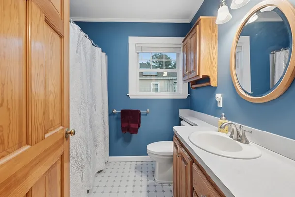 a bathroom with a sink a toilet and a mirror