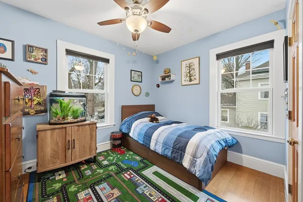 a bed sitting in a bedroom next to a window