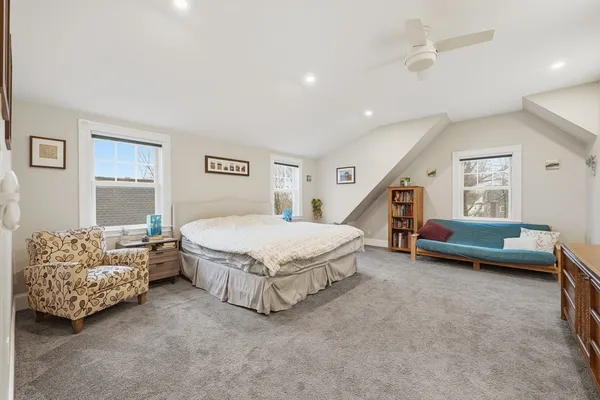 a spacious bedroom with a bed and a couch