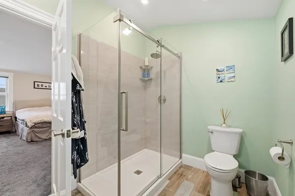 a bathroom with a toilet and a shower