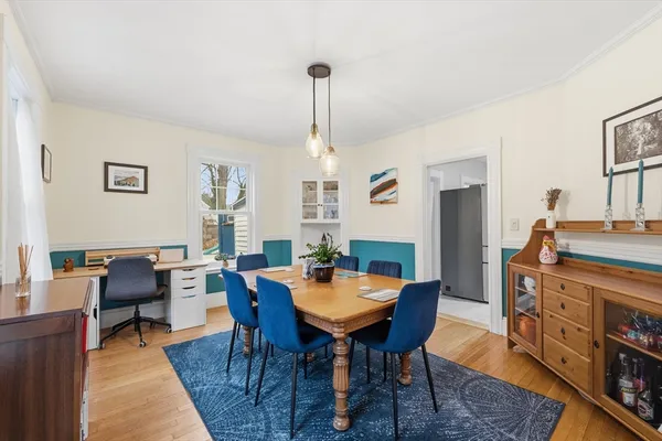 a dining room with furniture a rug and a chandelier