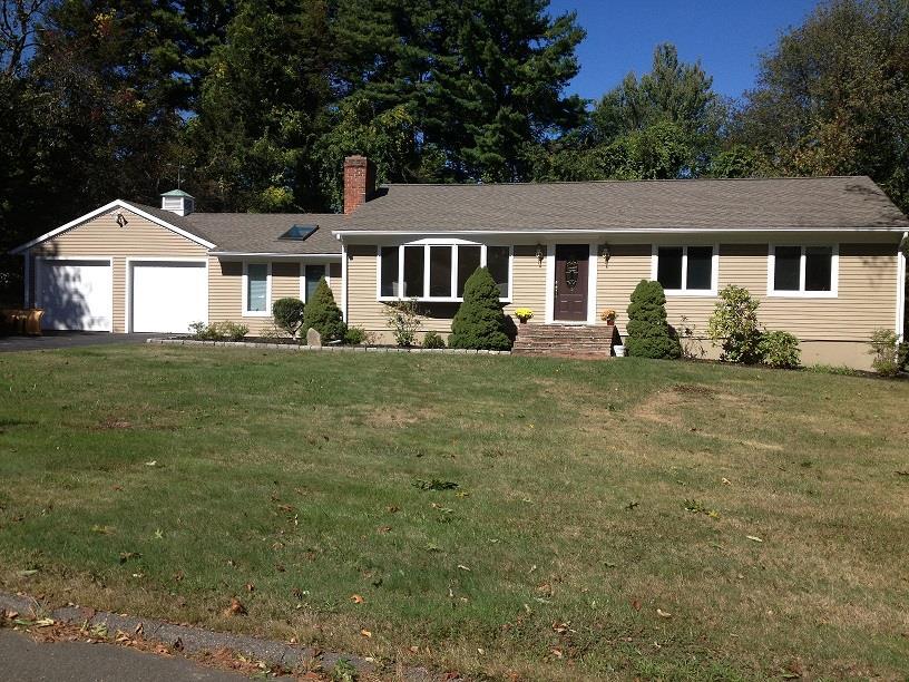 10 Laurie Road Trumbull, CT 06611 - Photo 1 of 1 a front view of a house with a yard and trees