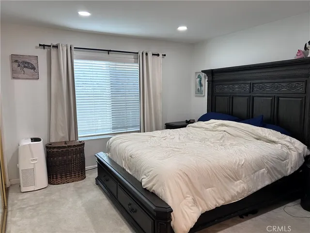 a bed sitting in a bedroom next to a window