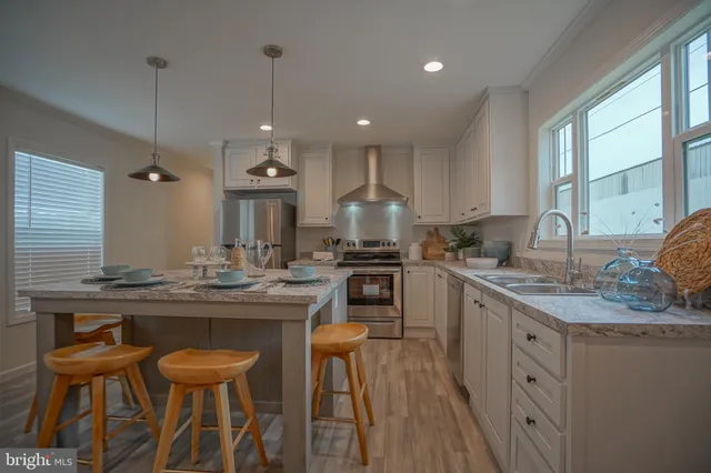 a kitchen with kitchen island granite countertop wooden cabinets and white appliances
