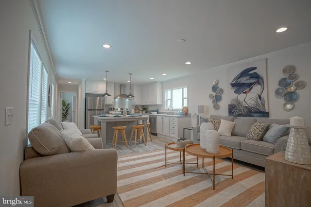 a living room with furniture and kitchen view