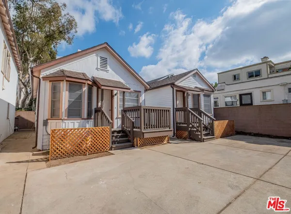 a view of a house with wooden fence