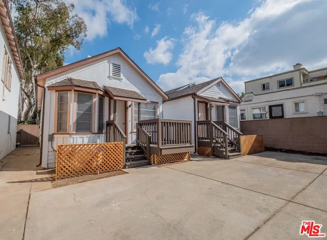 a view of a house with wooden fence