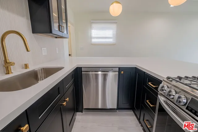 a kitchen with a sink and cabinets