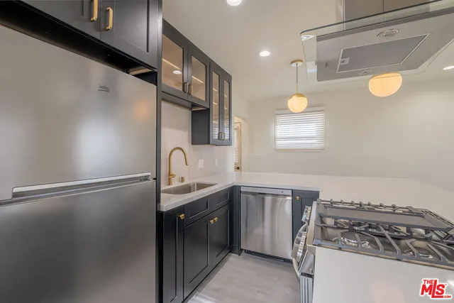 a kitchen with a sink and a stove top oven