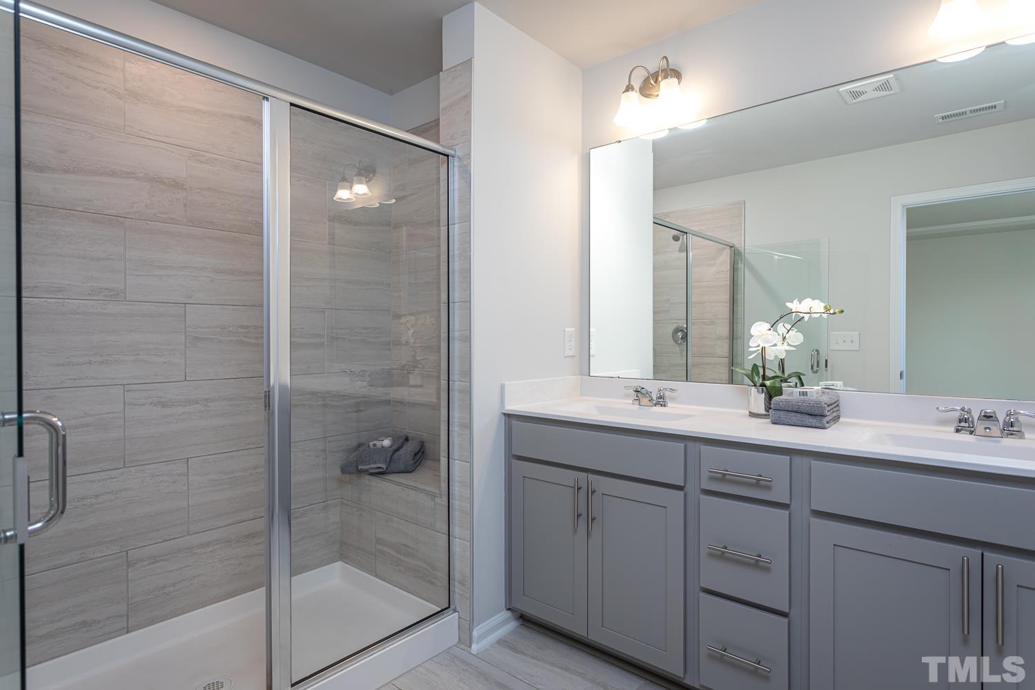 6531 Tremolo Trail Raleigh, NC 27616 - Photo 8 of 13 a bathroom with a double vanity sink and mirror
