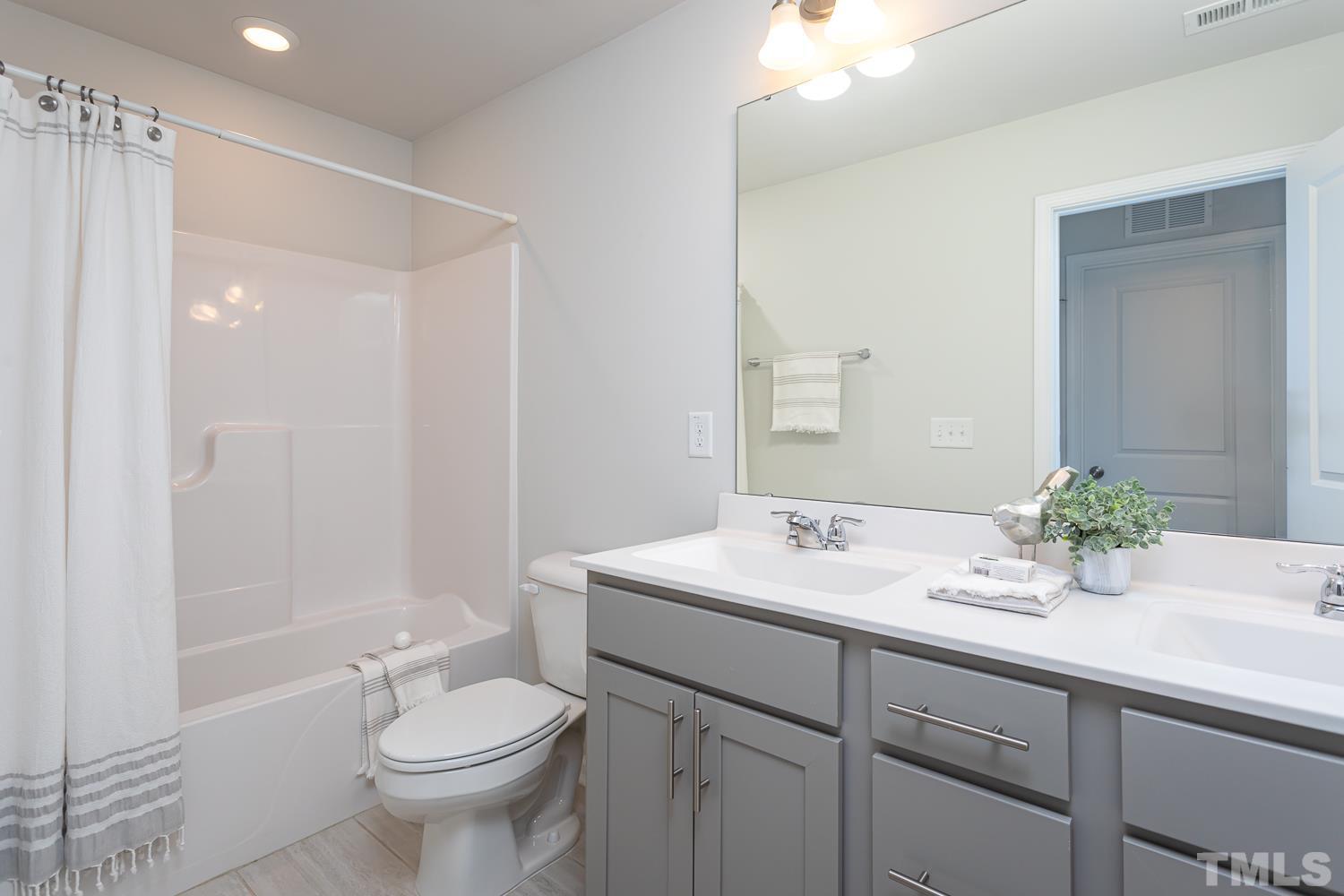 6531 Tremolo Trail Raleigh, NC 27616 - Photo 10 of 13 a bathroom with a sink toilet and shower