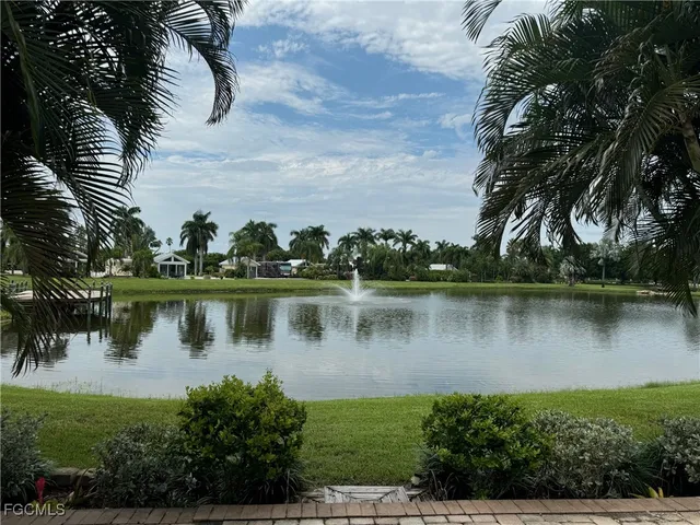 a view of a lake with a house in the background