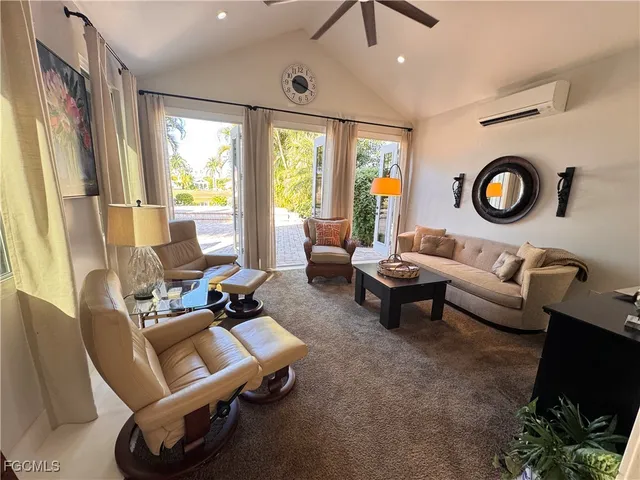 a living room with furniture a rug and a large window