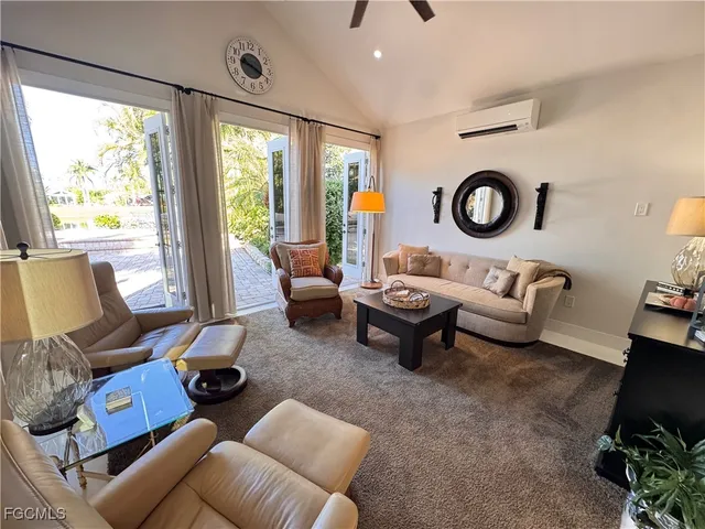 a living room with furniture and a floor to ceiling window