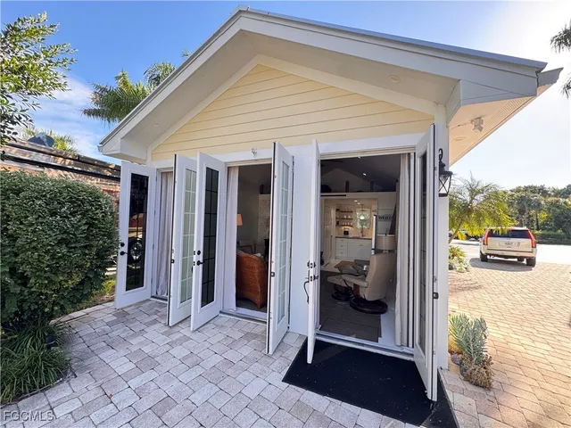 a view of a porch with furniture and floor to ceiling window