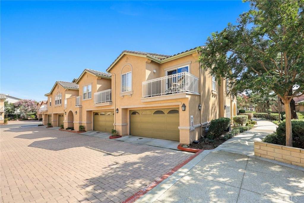 11450 Church Street, Unit 79 Rancho Cucamonga, CA 91730 - Photo 1 of 1 a front view of a house with a yard