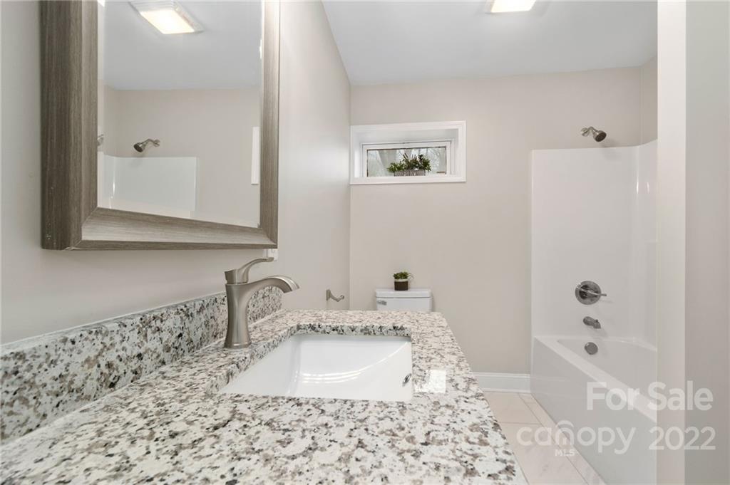 4418 Watson Church Road Marshville, NC 28103 - Photo 26 of 37 a bathroom with a sink and a mirror