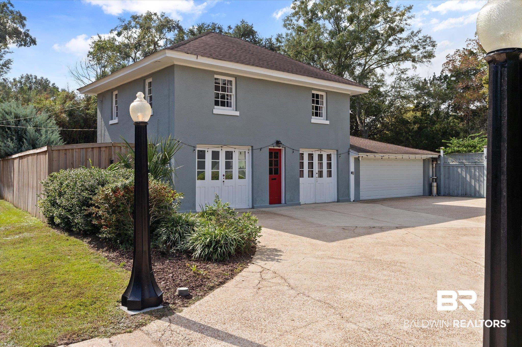 1953 Dauphin Street Mobile, AL 36606 - Photo 37 of 56 View of front of house featuring an outbuilding, a garage, and a front lawn