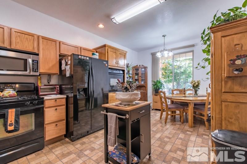 2771 Harding Way Reno, NV 89503 - Photo 6 of 24 a kitchen with stainless steel appliances granite countertop a stove refrigerator and a dining table