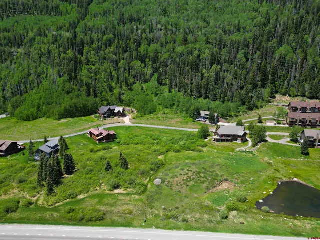 a backyard of a house with a yard and outdoor seating