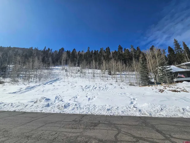 a view of dirt road with a building in the background