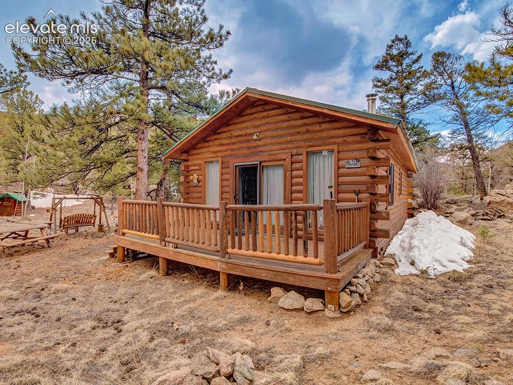 1462 Pulver Road Lake George, CO 80827 - Photo 1 of 25 a view of a small house with wooden fence