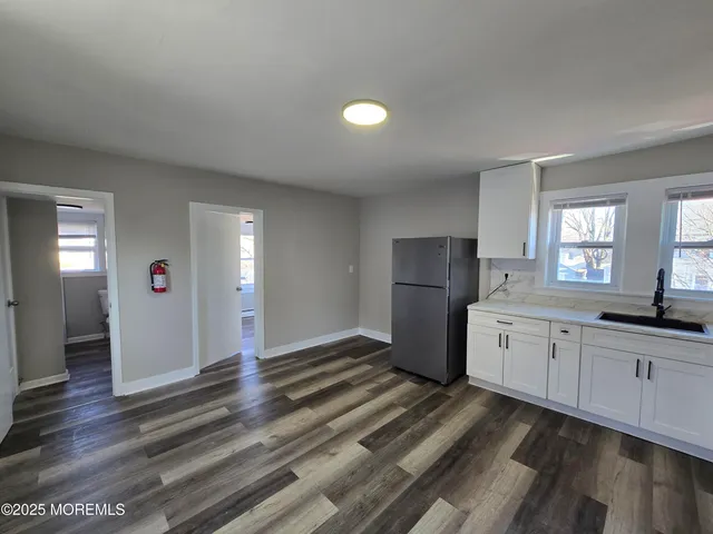 a spacious bathroom with a granite countertop sink and a mirror