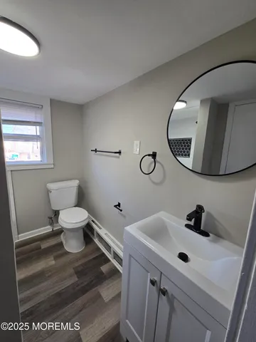 a bathroom with a sink mirror and toilet