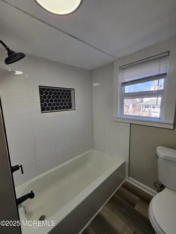 a bathroom with a toilet a sink and a bathtub