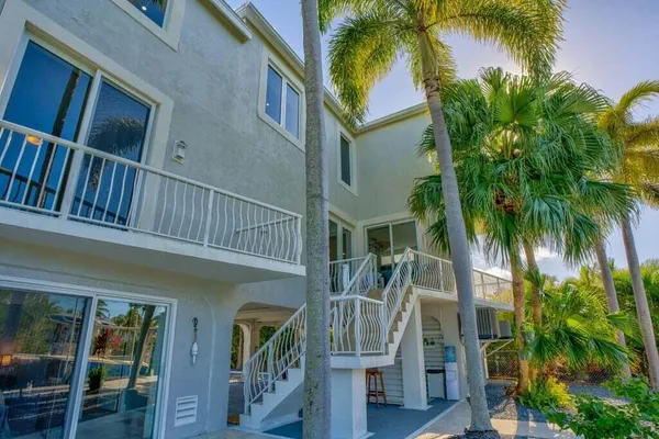 a view of the patio with chairs under an umbrella