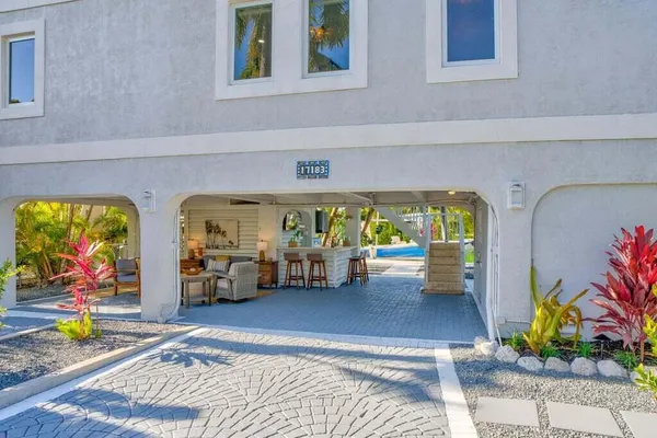 a kitchen with stainless steel appliances granite countertop a refrigerator a stove a sink dishwasher and a refrigerator with wooden floor