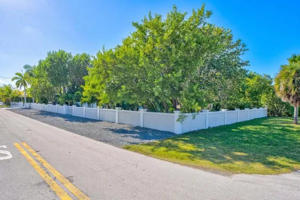 a bedroom with a bed chandelier and a window